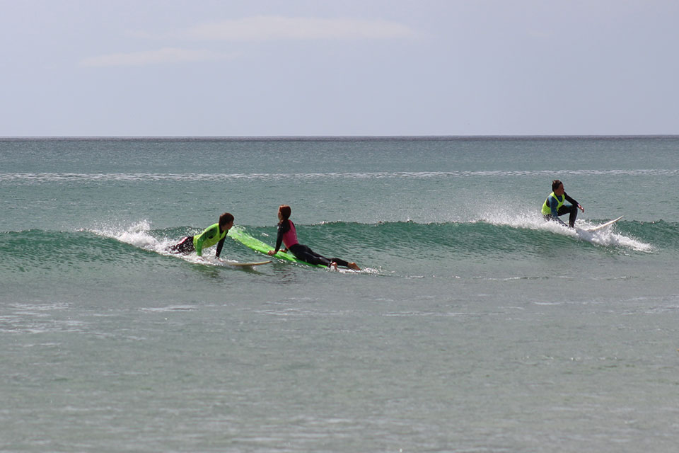Students surfing at Waihi Beach